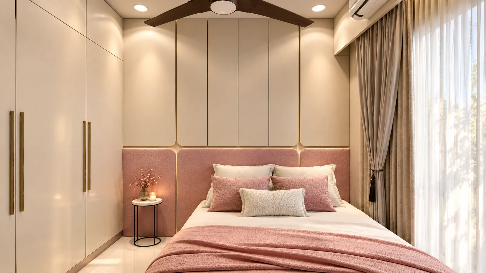 A bedroom with a pink upholstered headboard, cream wall panelling, tall wardrobes with brass handles and soft curtains